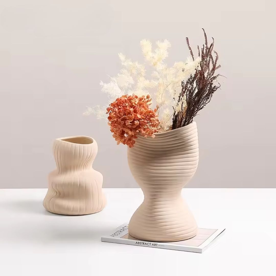 Beige vertical curved vase by BEACON, elegant ceramic container with a sleek, modern design for floral arrangements.