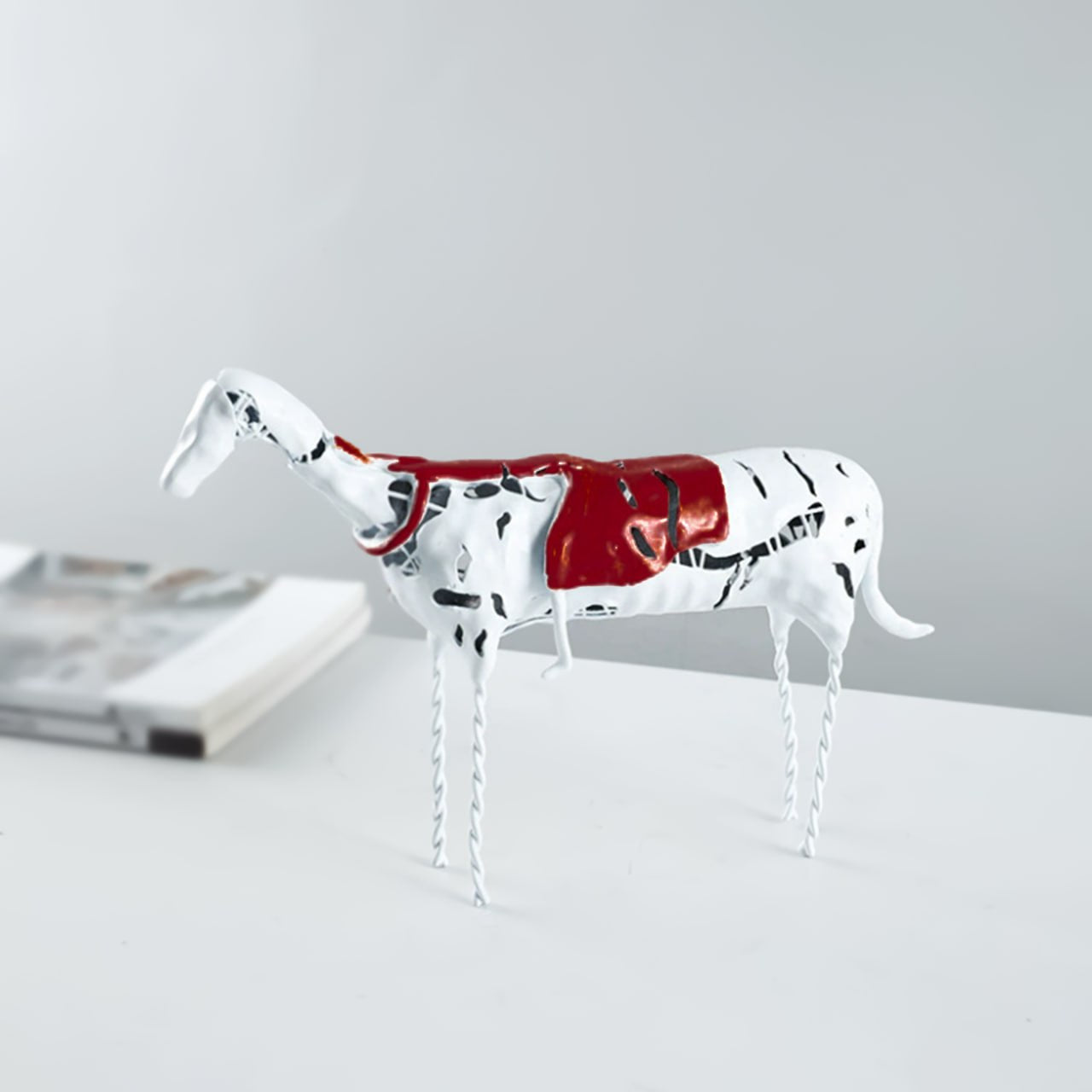 White resin figurine of a sleeping girl on a horse, home decor sculpture by Beacon, detailed and artistic ceramic figure.