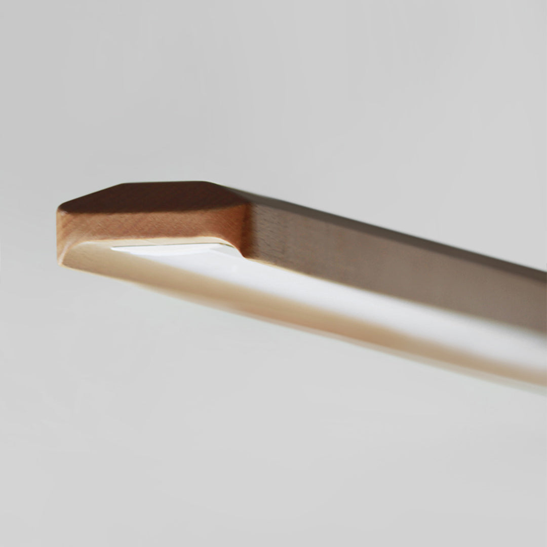 Woodland Charm LED linear pendant lamp in natural ash finish, modern pendant light fixture with sleek design and warm lighting.
